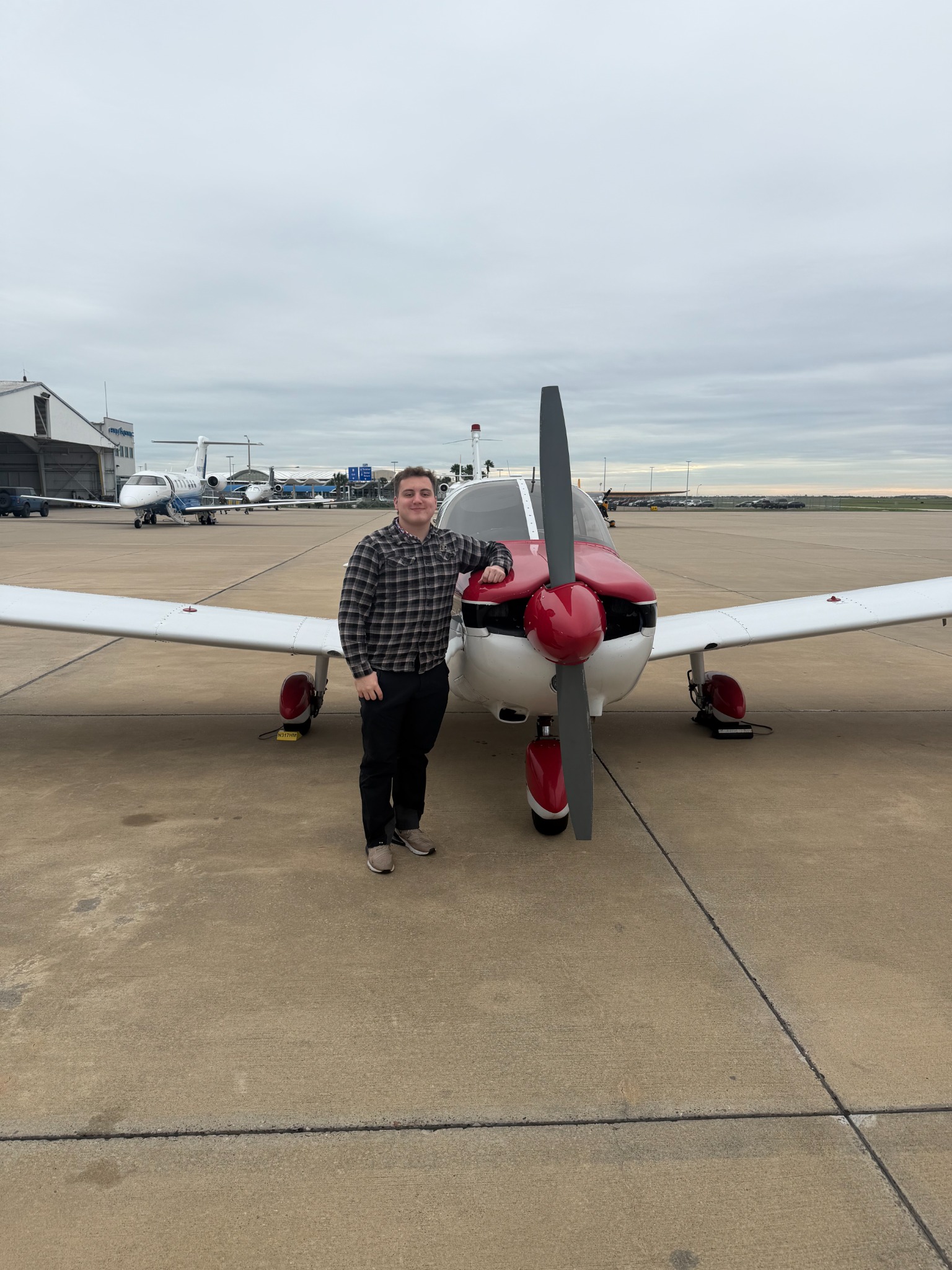 Splendid Aviation student standing with a training aircraft